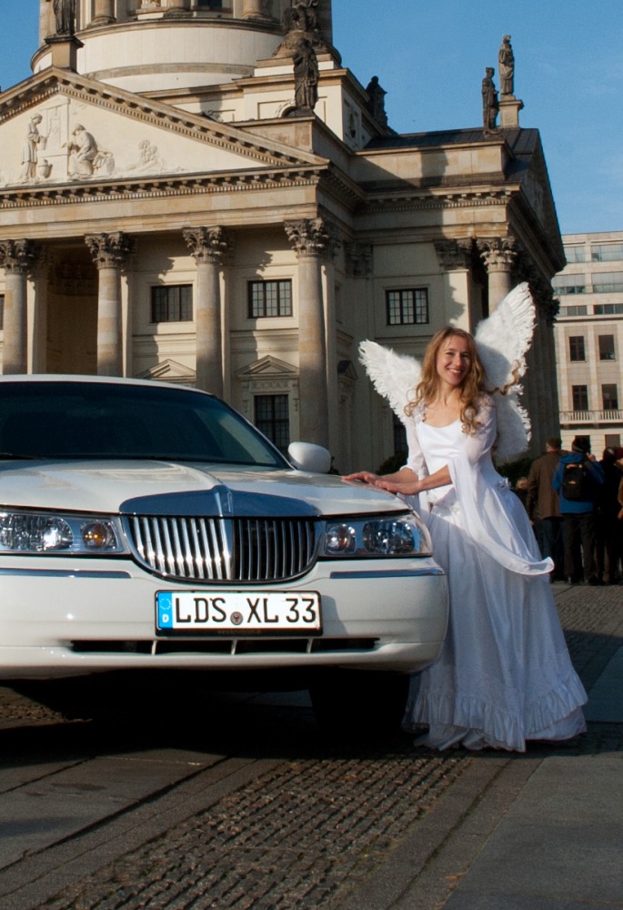 Engel Angela neben einer weißen Limousine am Gendarmenmarkt